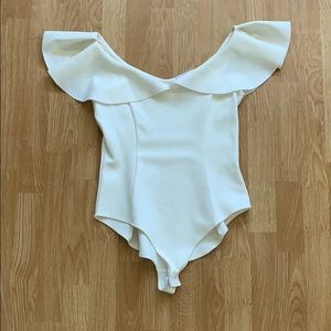 Cream, ruffled double v-neck bodysuit.